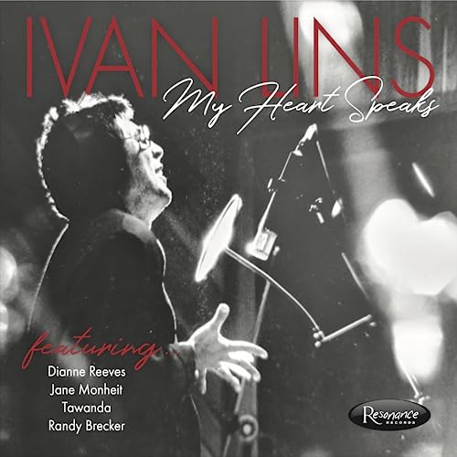 Black and white CD cover of Ivan Lins performing into a microphone.