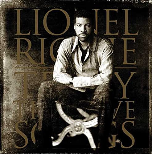Lionel Richie sits on a stool against a dark, textured background with album text.