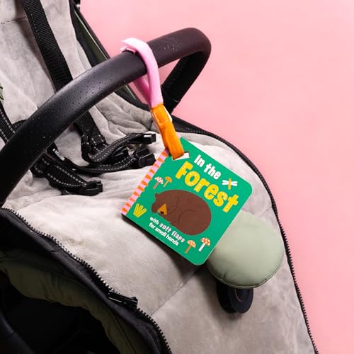 Small board book with a bear on the cover, hanging from a stroller.