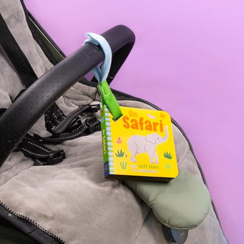 An On Safari board book with an elephant illustration hanging from a stroller handle.
