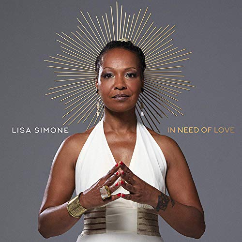 "Album cover featuring Lisa Simone in white, with gold accents and gray background."