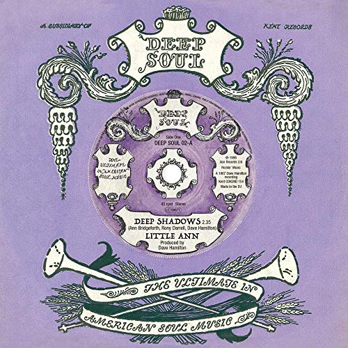 Purple and white vinyl record label with ornate floral designs and text.
