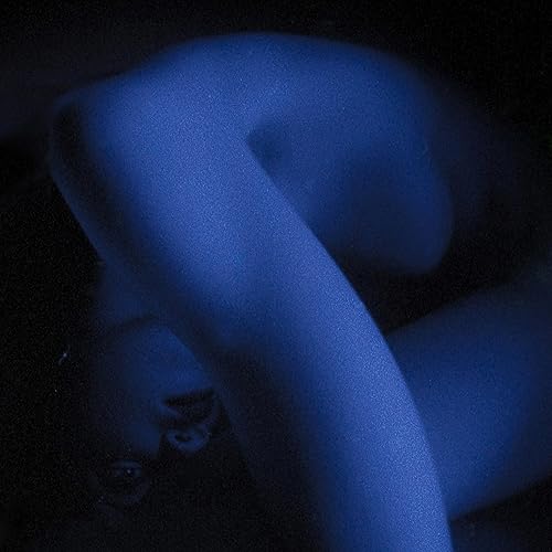 Blue-toned, blurred image of a person’s back and arm.