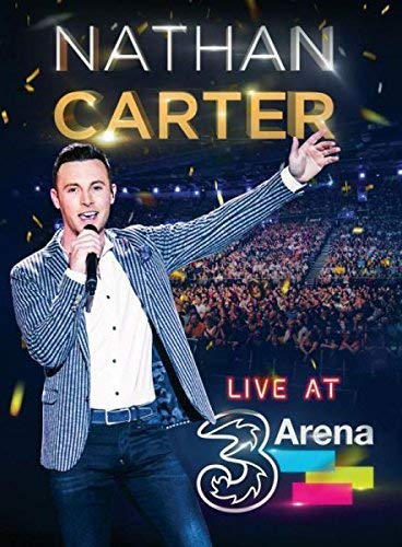 Nathan Carter performing live on stage with a large audience.