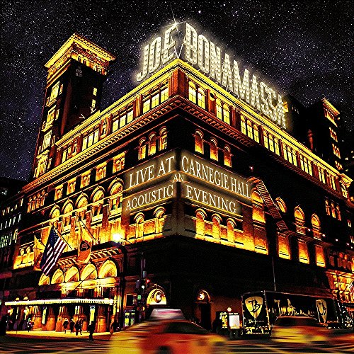 Carnegie Hall illuminated at night with "Live At Carnegie Hall" signage.