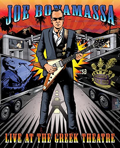 Illustrated Joe Bonamassa playing a V-shaped guitar in front of concert stage equipment.