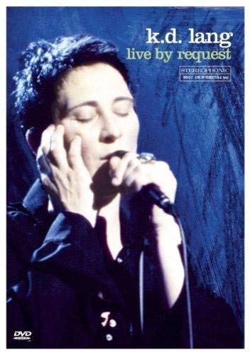 k.d. lang singing into a microphone on a blue “Live By Request” DVD cover.
