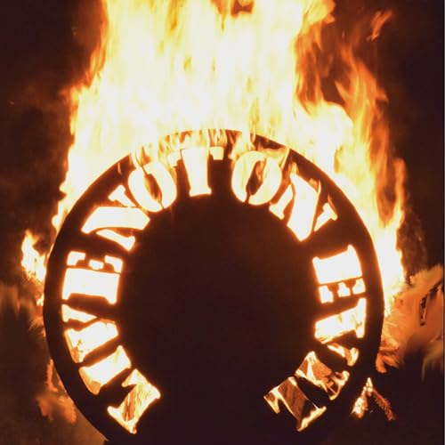 Burning circular object with lettering against a fiery, dark background.