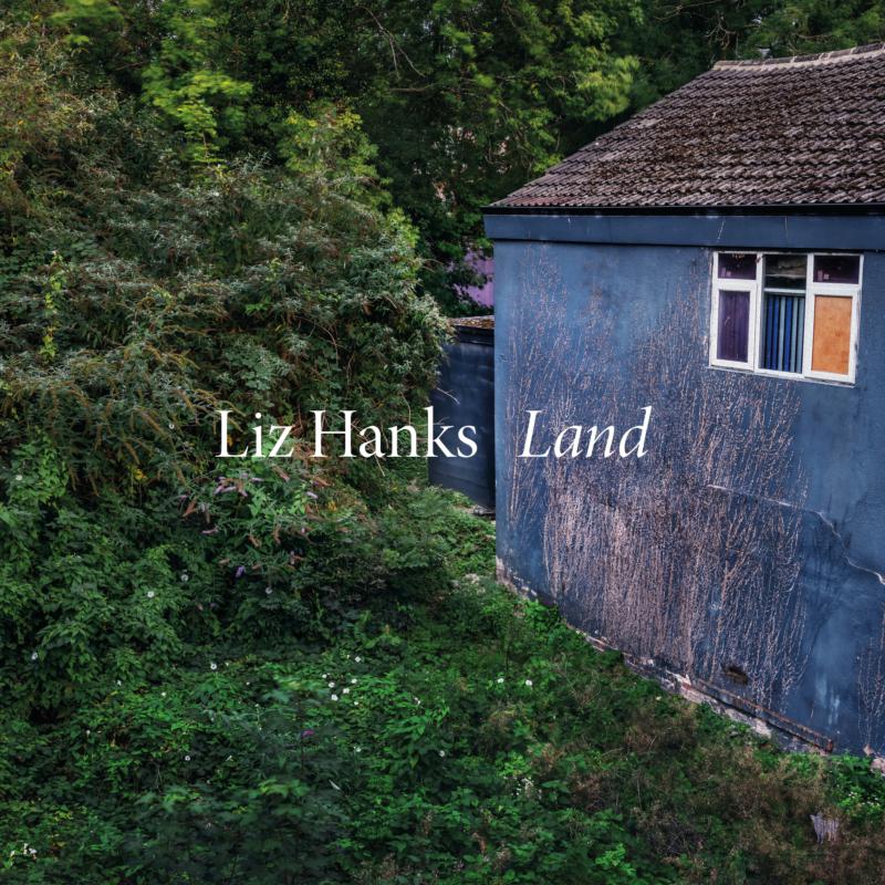 Album cover for Liz Hanks’ “Land” featuring a blue building exterior.