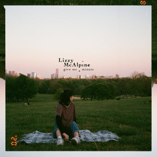 CD cover: Lizzy McAlpine sits in a park with a city skyline.