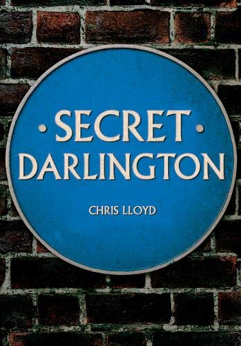 Blue plaque reading "Secret Darlington" against a brick wall.