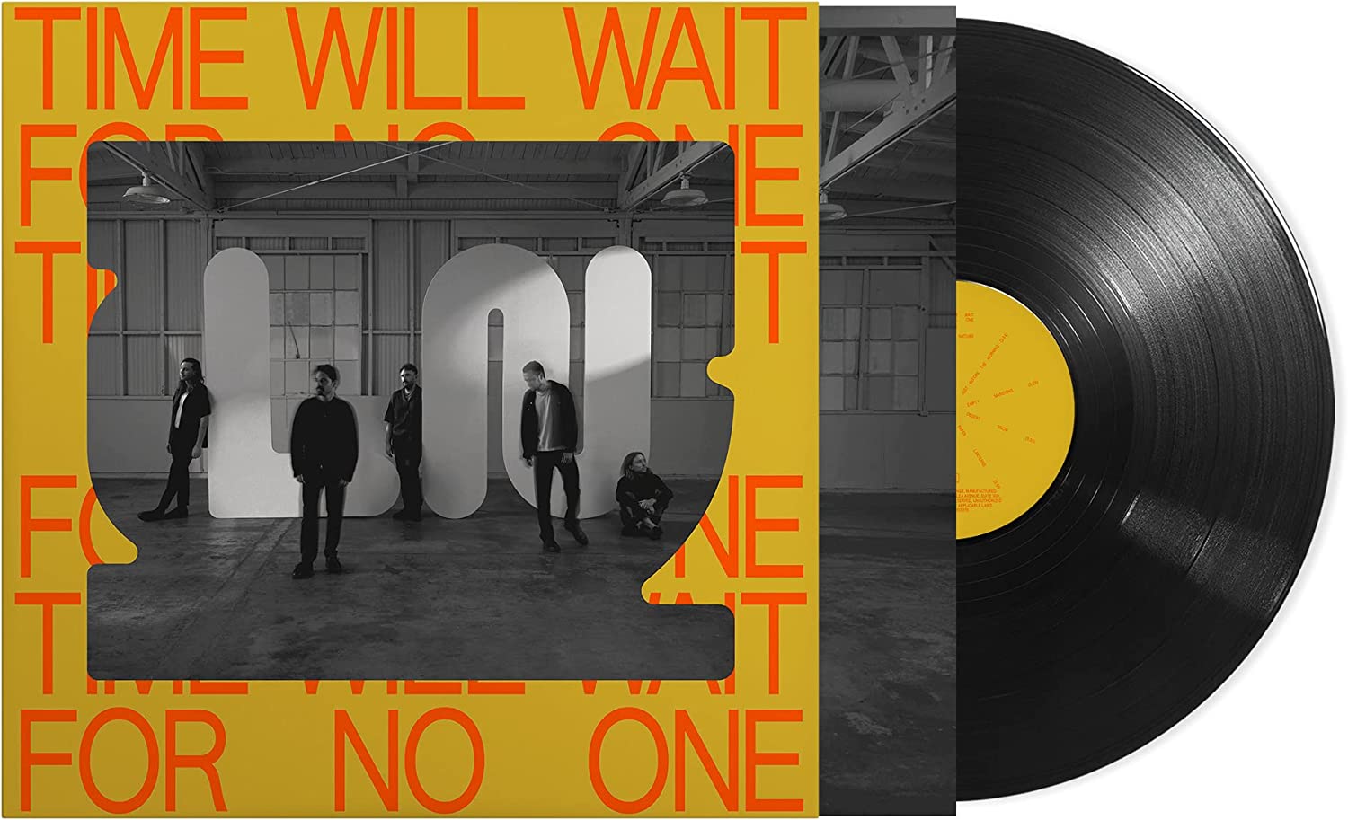 Vinyl record with a yellow label and album cover featuring a black-and-white band photo.