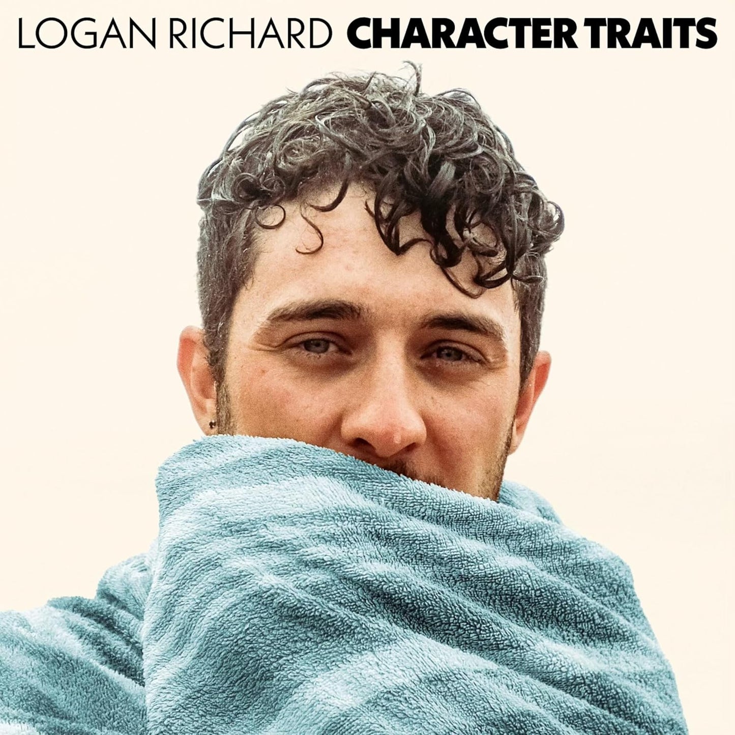 Album cover featuring Logan Richard with curly hair and a blue towel.