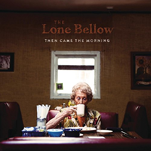 Album cover: elderly woman drinking from a mug at a table, with text above.