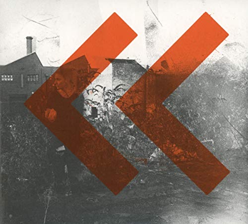 Gritty black and white industrial scene with two large orangeS orange chevron overlays.
