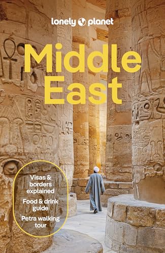 A person in traditional clothing walks between ancient stone columns carved with Egyptian hieroglyphs.