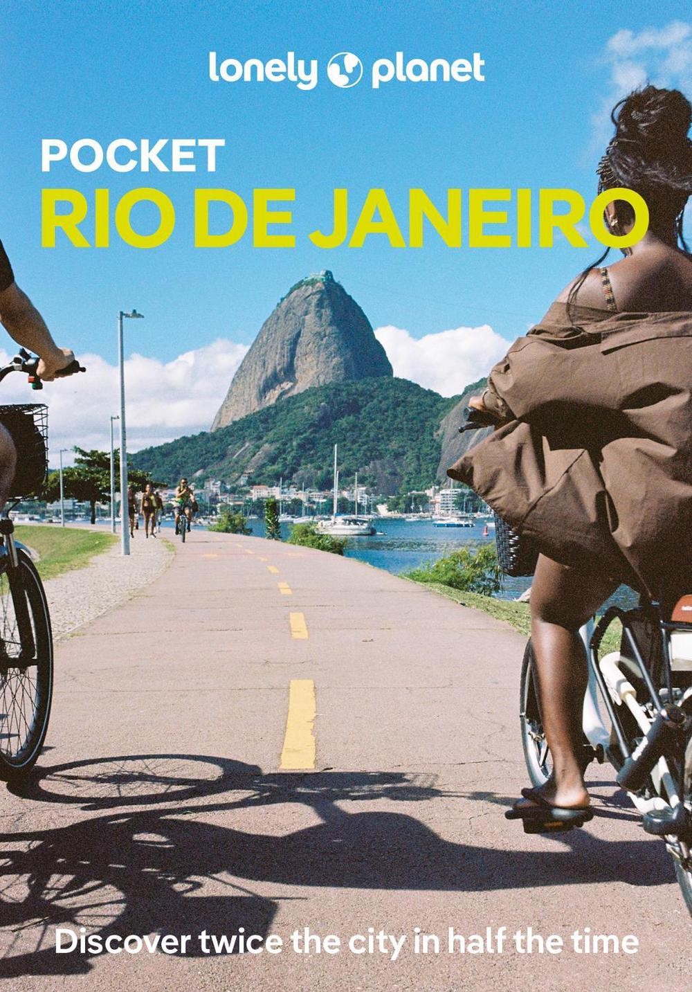 People riding bicycles on a path with Sugarloaf Mountain in the background.