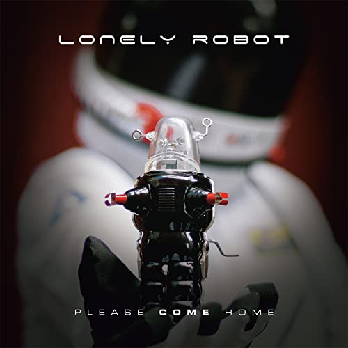 Small robot with a glass head held by an astronaut in a white suit.