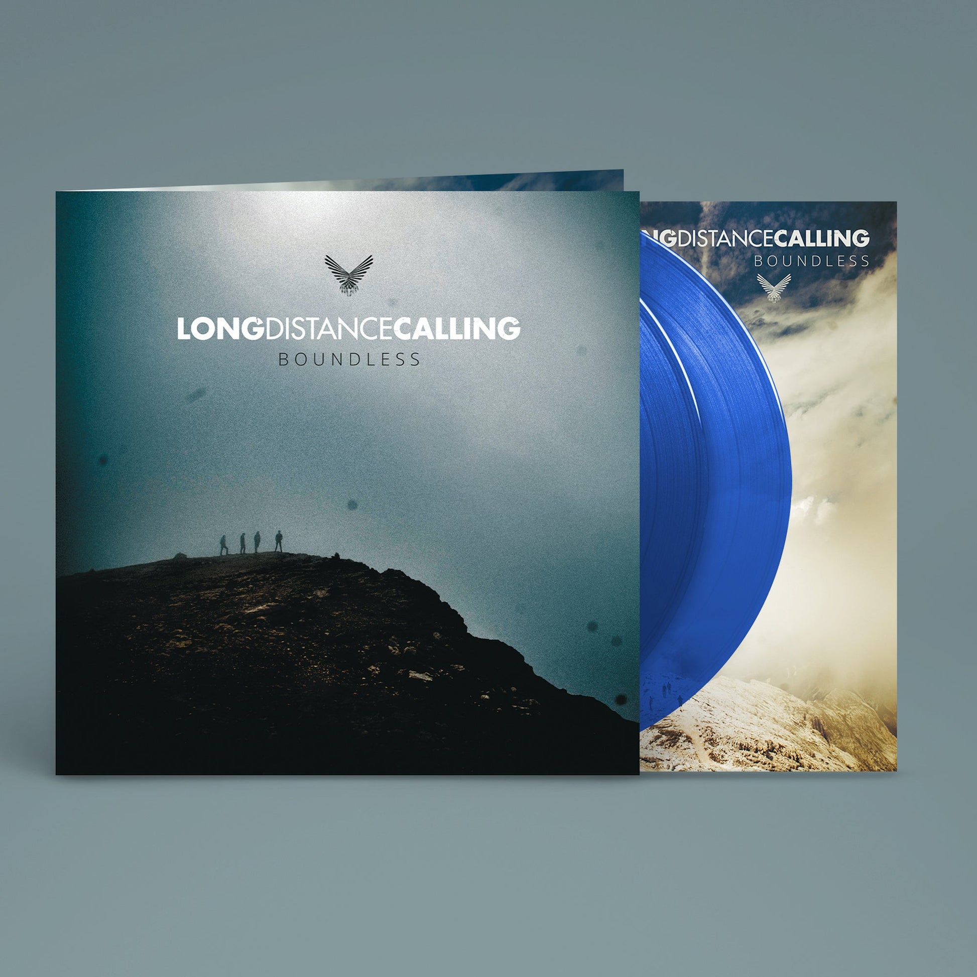 Blue vinyl record partially pulled from its album cover featuring a mountain landscape.