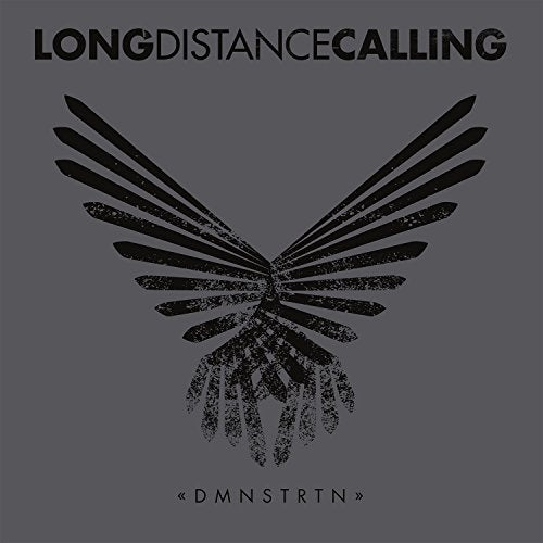 A vinyl record cover with a black bird-like design on a gray background.