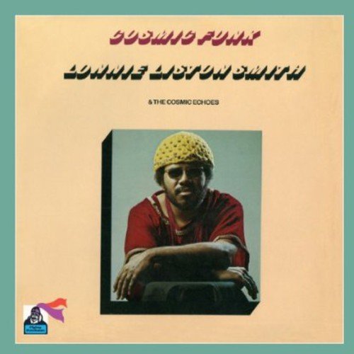 Album cover with a man in a yellow knit cap on a peach background.