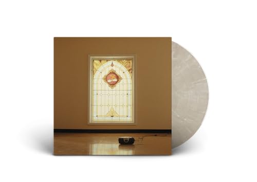 Vinyl record with cover showing a stained glass window and wooden floor.