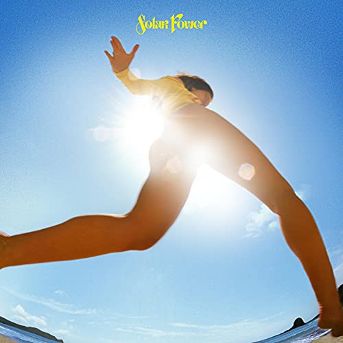 Lorde album cover: low-angle shot of a person reaching toward the sun.