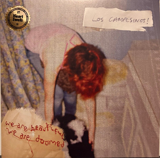 Album cover: person with red hair, text “we are beautiful, we are doomed”.