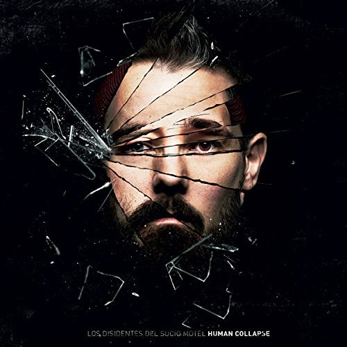 Close-up of a man’s face fractured by shattered glass, dark background.
