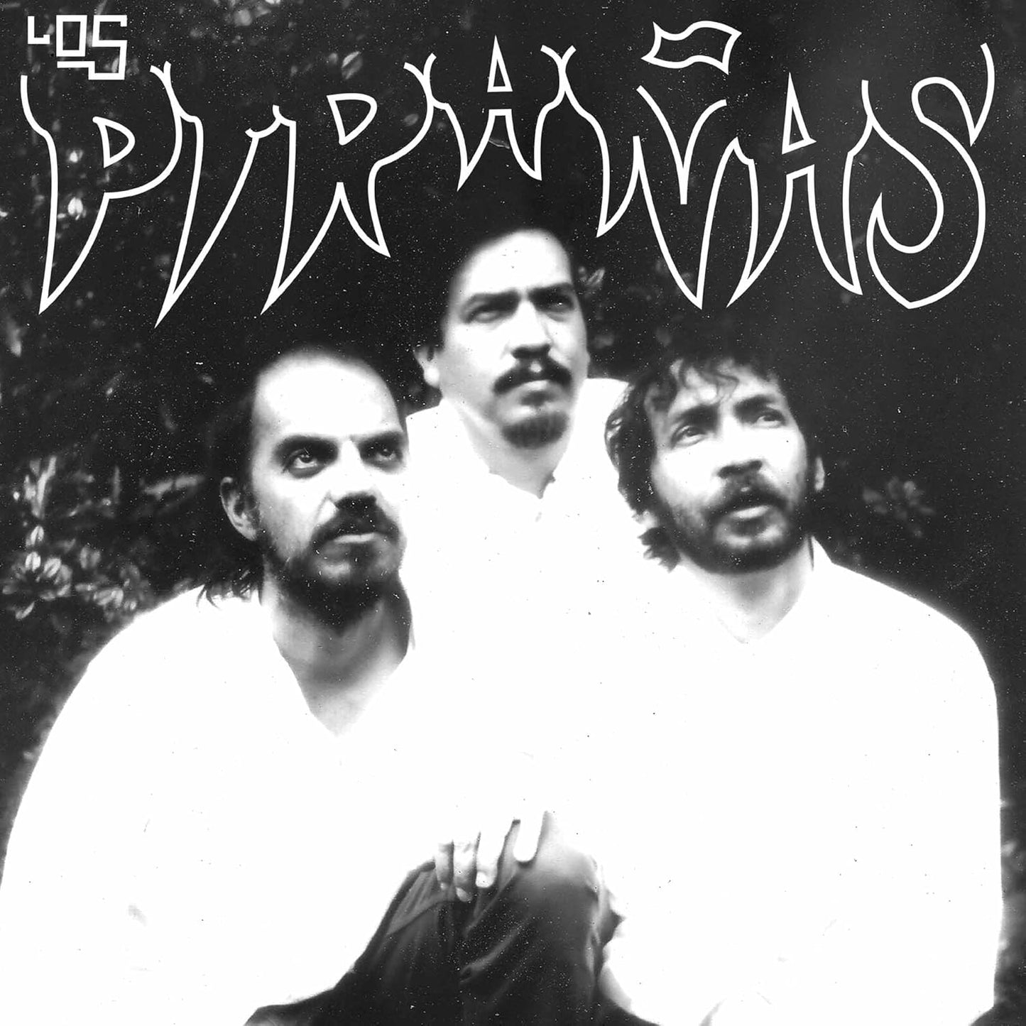 Black and white CD cover featuring three men and band logo.