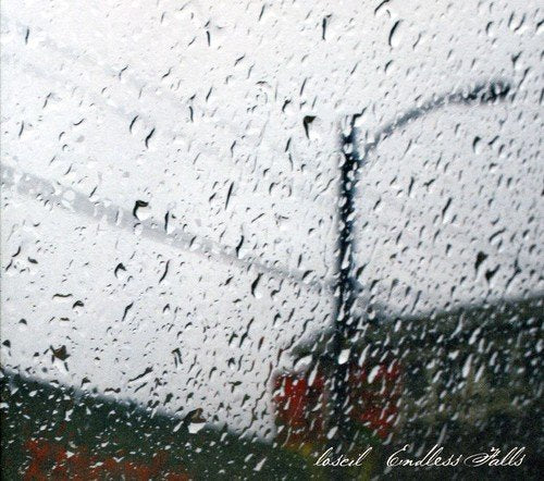 The image shows a rainy window with a CD and text overlay. Alt text: Rainy window with "loscil Endless Falls" text and CD overlay.