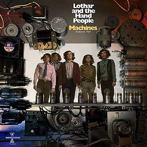 Vinyl album cover featuring five men standing on metal cylinders surrounded by machinery parts.