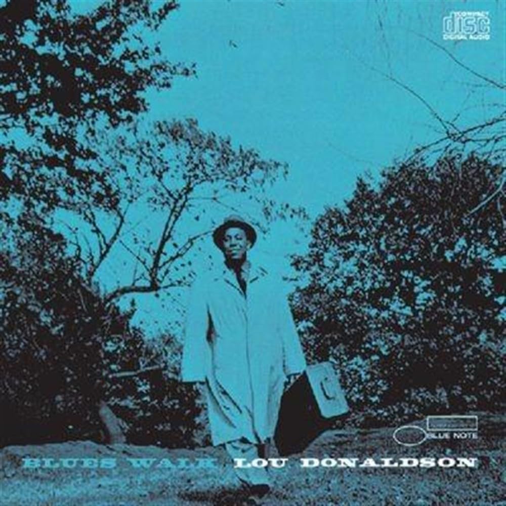 CD cover for Lou Donaldson’s “Blues Walk” featuring a man with a saxophone case.