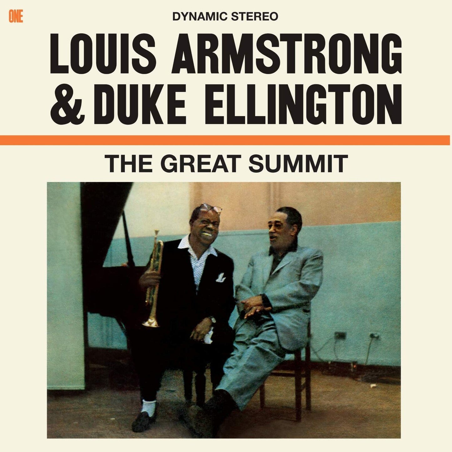 Louis Armstrong holding a trumpet and Duke Ellington sitting together in a studio.
