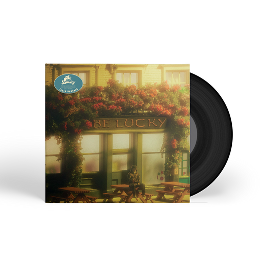 Vinyl record cover showing a person sitting at a pub table with floral decor.