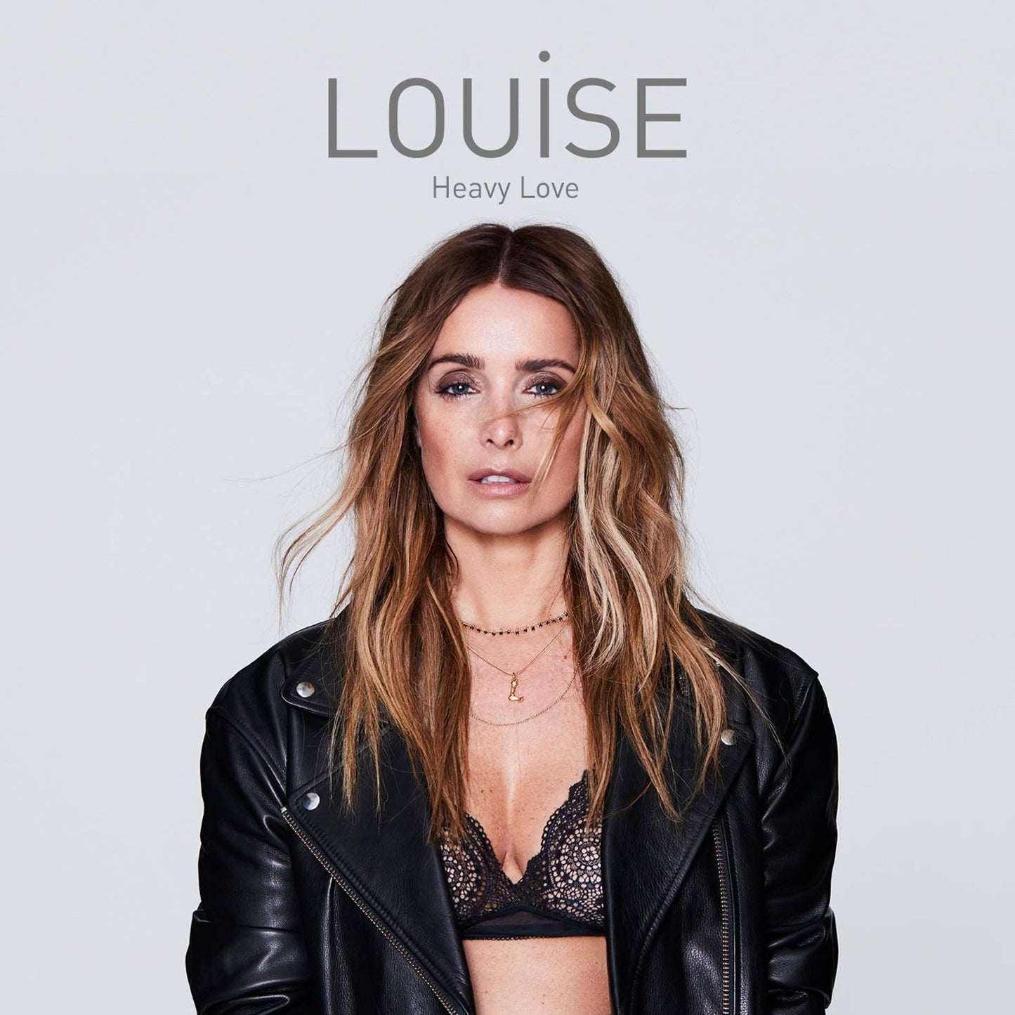 "Album cover featuring a woman in a leather jacket and bra against a white background."