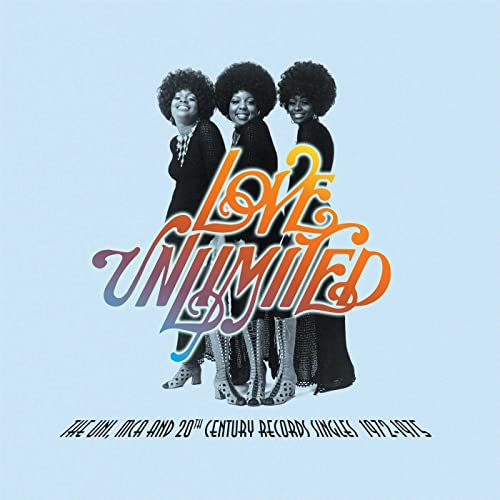 Three women in black outfits and afro hairstyles on light blue album cover background.