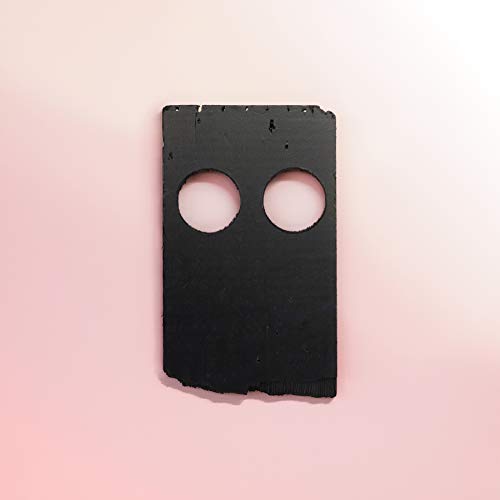 A black rectangular object with two circular cutouts centered on a pale pink background.