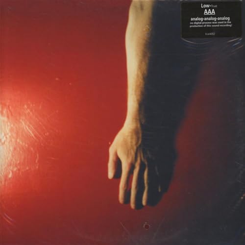 Red vinyl record cover with a blurred image of an arm and hand.
