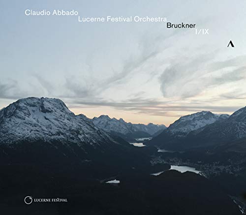 CD cover featuring a serene mountain landscape with snow-capped peaks and a lake.
