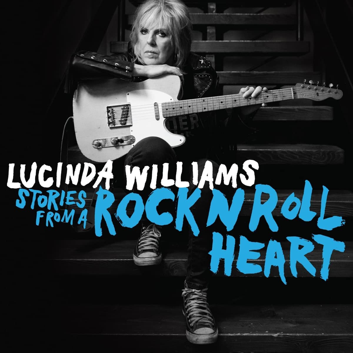 Lucinda Williams sits on stairs holding an electric guitar, with album title text overlaid.