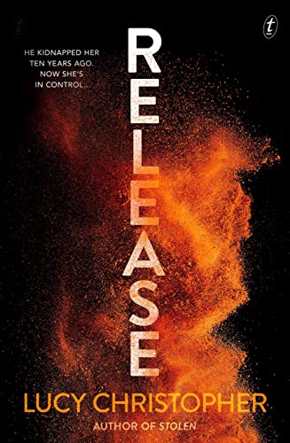 Book cover titled Release by Lucy Christopher with orange powder exploding against black background.