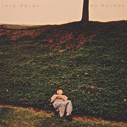 CD cover: woman lying in grass under a tree, landscape background.