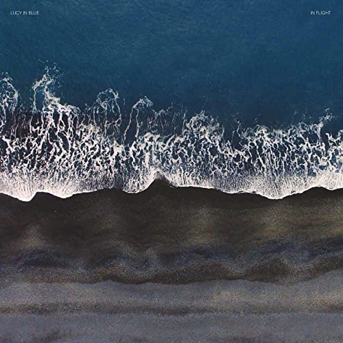 CD cover: aerial view of ocean waves breaking on a dark beach.