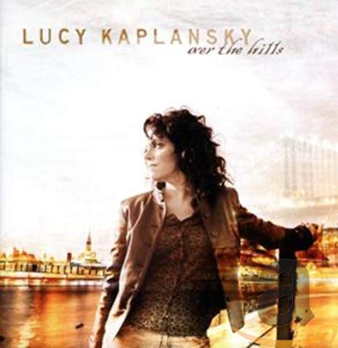 Lucy Kaplansky album cover, woman in jacket with city background.