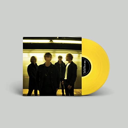 Yellow vinyl record with album cover showing four people in a tunnel.