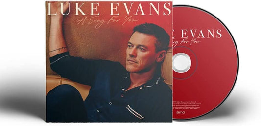 "CD case with red disc and photo of man sitting on a couch."