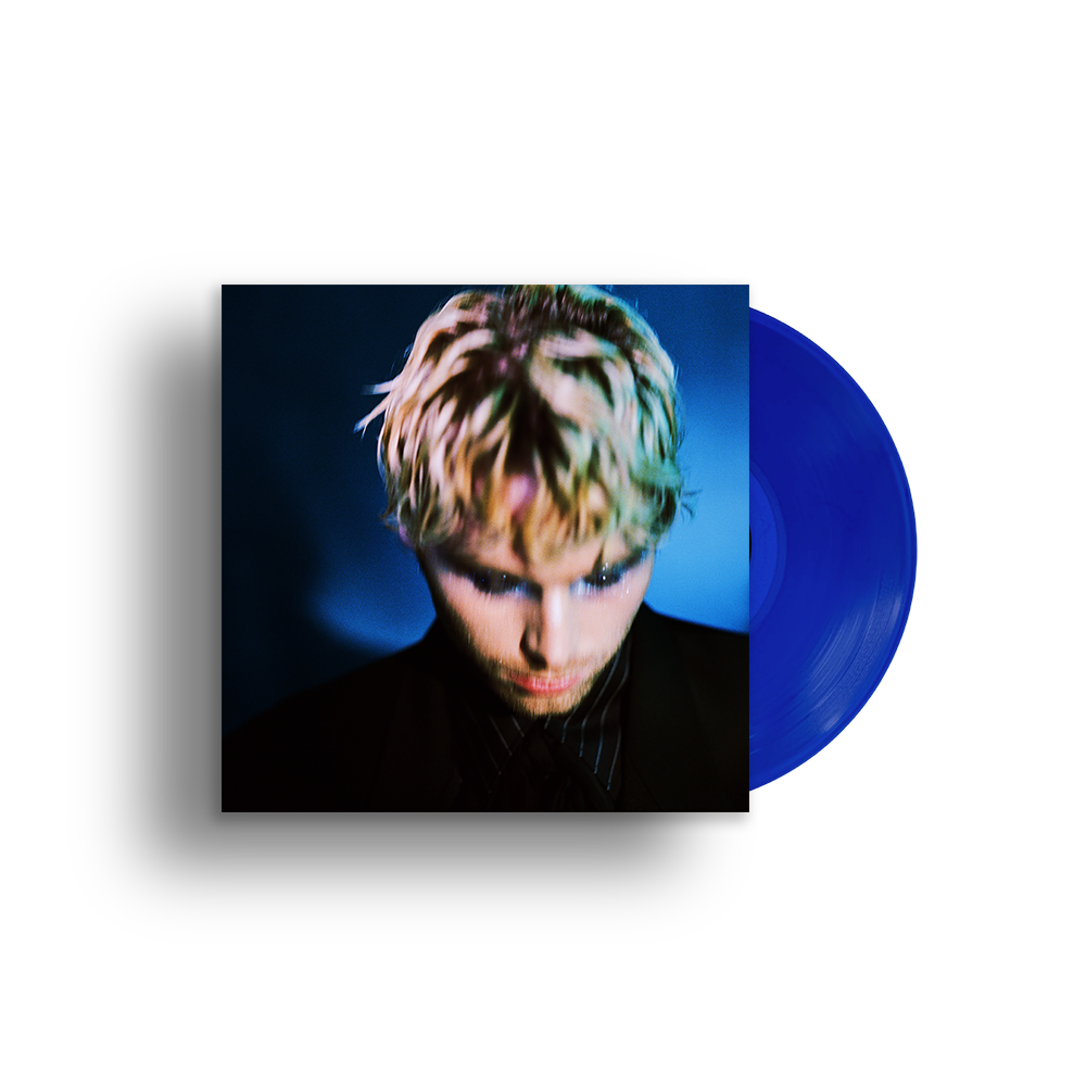 Luke Hemmings Boy album cover featuring a portrait next to a blue vinyl record.