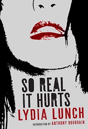 Book cover: stark white face with red lips and title "So Real It Hurts.
