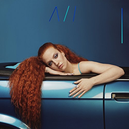 Red-haired woman lying on a blue car roof, album cover.